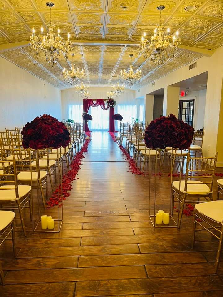 Ceremony aisle with red rose arrangements