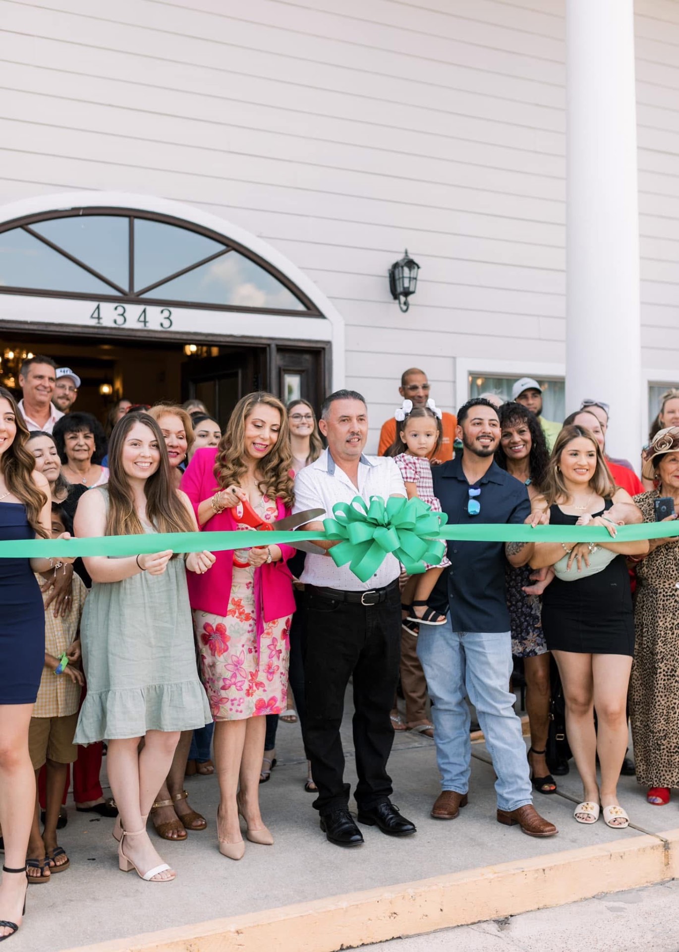 Ribbon-cutting celebration at Maison D'Amis with family and friends