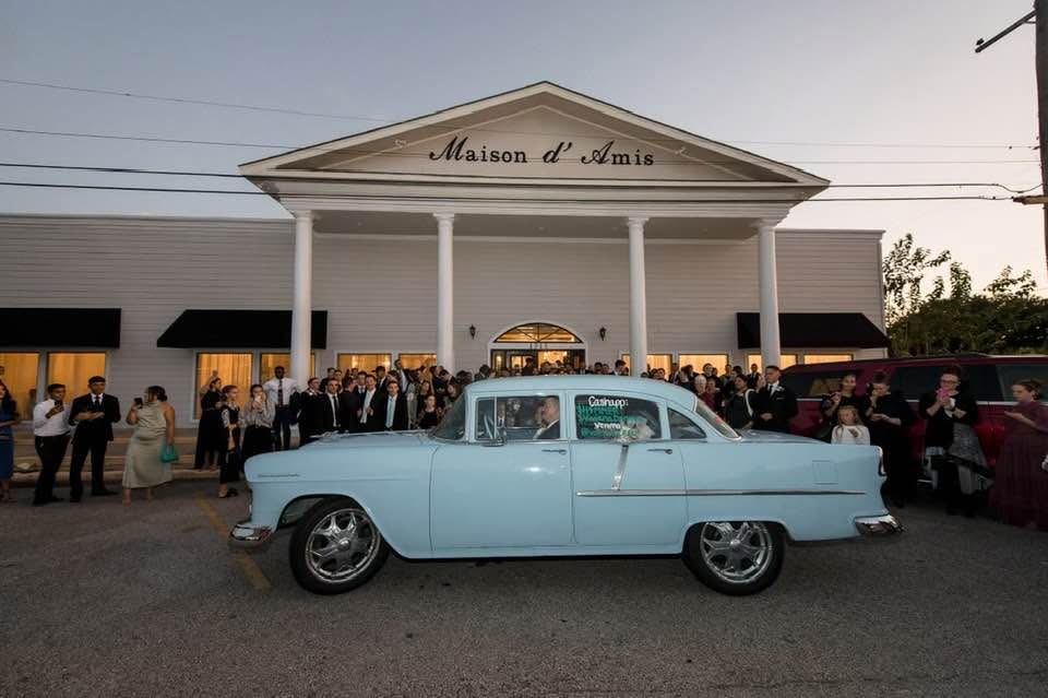 Maison d'Amis exterior at night with vintage car