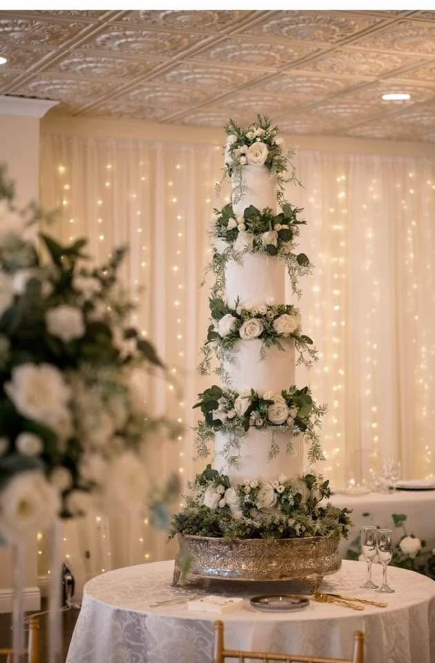 Tiered wedding cake with cascading florals