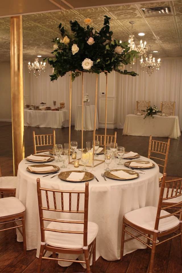 Tall gold candelabra centerpiece with florals