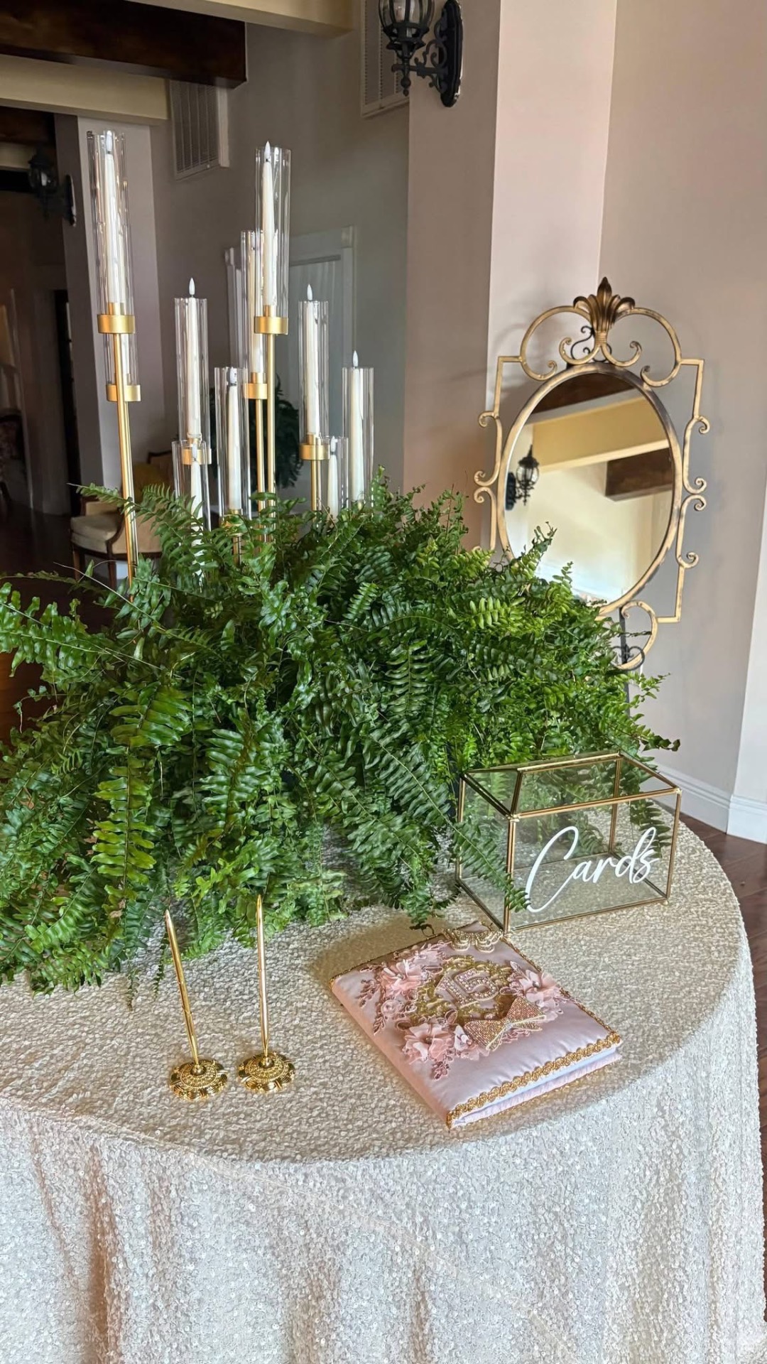 Cards table with ferns, candles, and gold accents