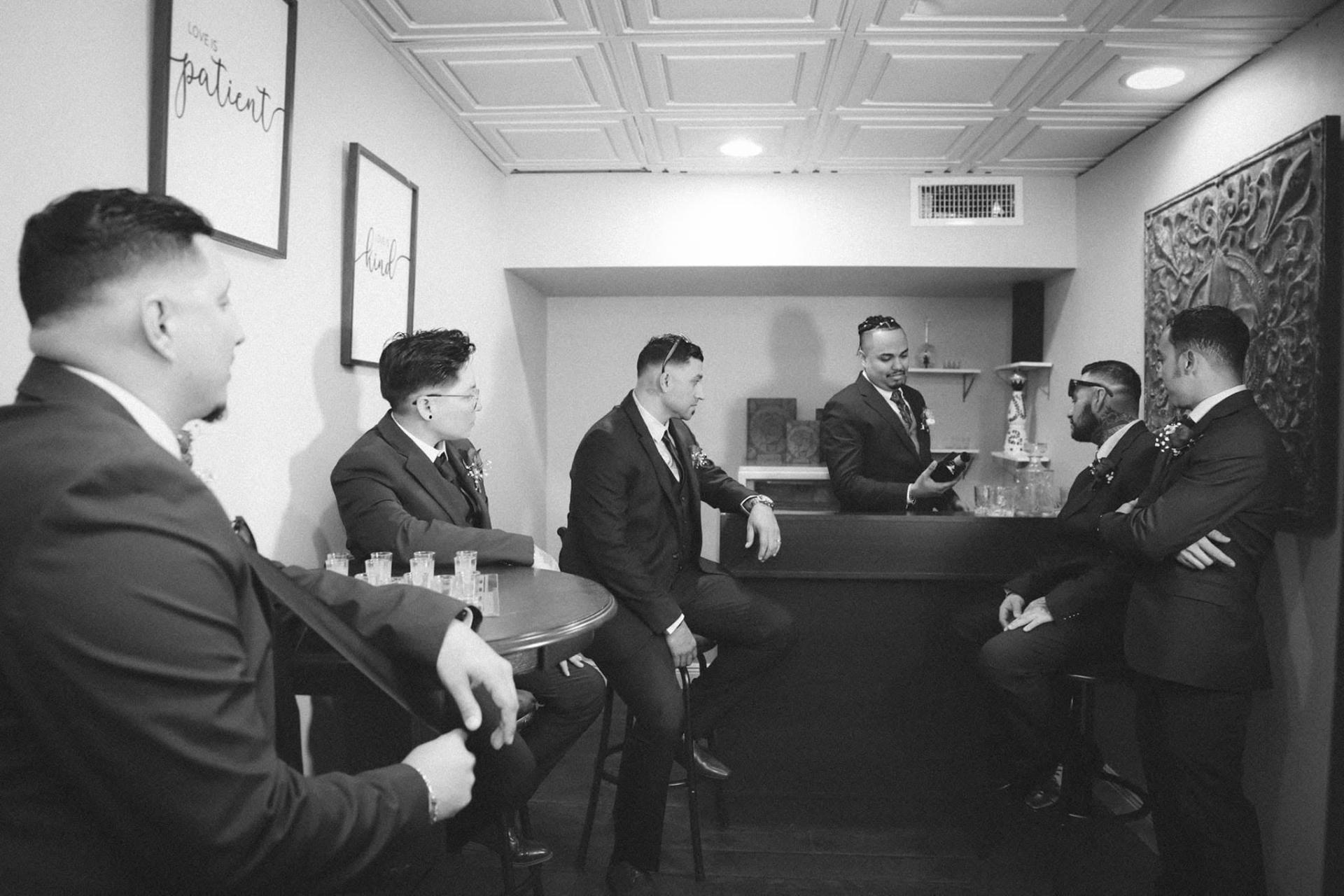 Groomsmen gathered in the private bar suite before the ceremony