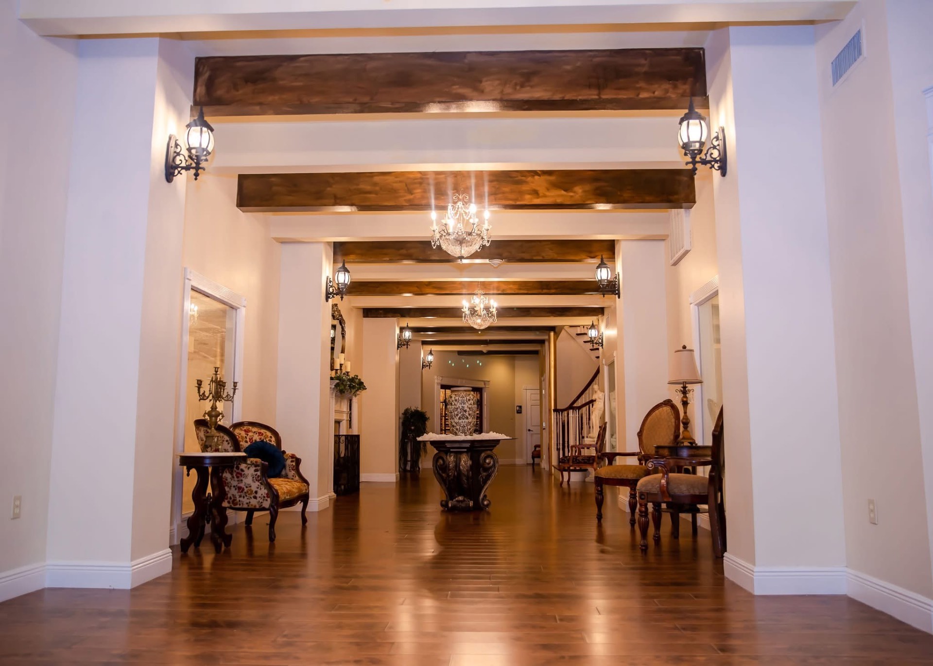 Entryway with wood beams and chandelier